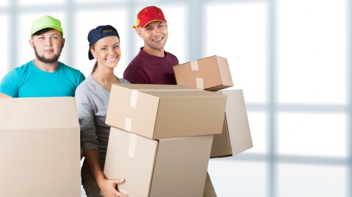 Professional movers loading household items in Collierrow