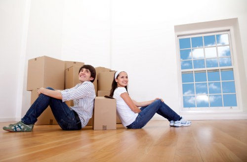 PPE and safety-focused moving team loading items securely into a van