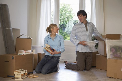 Professional movers carrying furniture through a residential property