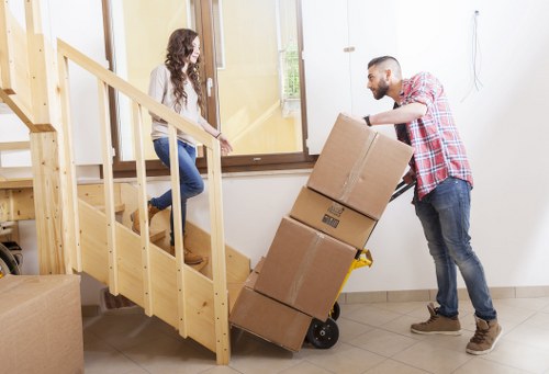 Removal crew handling furniture near a Collierrow property