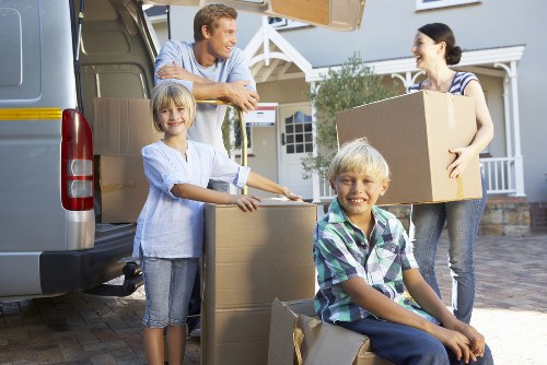House moving team handling bulky furniture in a Collierrow property