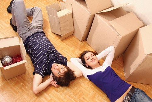 Removal crew loading household items with protective wrapping during a Collierrow move