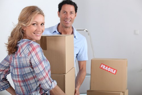 Packed household boxes and furniture ready for removal in Collierrow